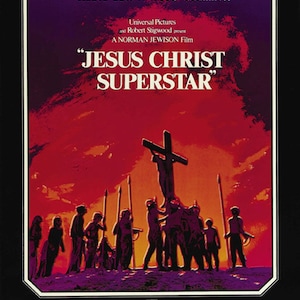 May include: A film poster for the movie "Jesus Christ Superstar" featuring a silhouette of Jesus Christ on the cross with a group of people in the foreground. The poster is in shades of red, orange, and yellow.