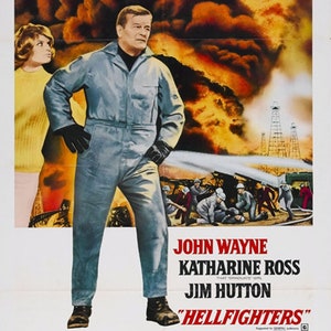 May include: A movie poster for the film "Hellfighters" starring John Wayne, Katharine Ross, and Jim Hutton. The poster features a fiery explosion in the background with oil derricks and a group of people running away from the flames. The text on the poster reads "Hellfighters" and features the names of the actors.