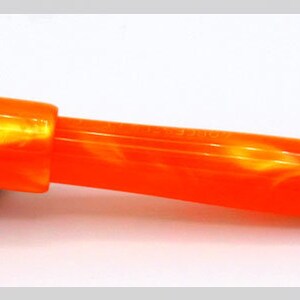 May include: Orange and gold fountain pen with a marbled orange body and a gold nib.