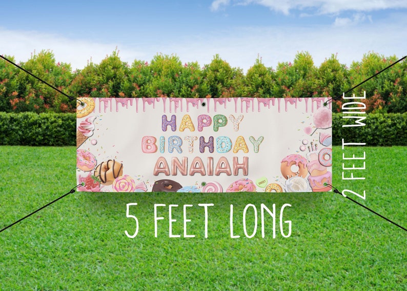 May include: A pink and white birthday banner with donut sprinkles and the text "Happy Birthday Anaiah". The banner is 5 feet long and 2 feet wide.