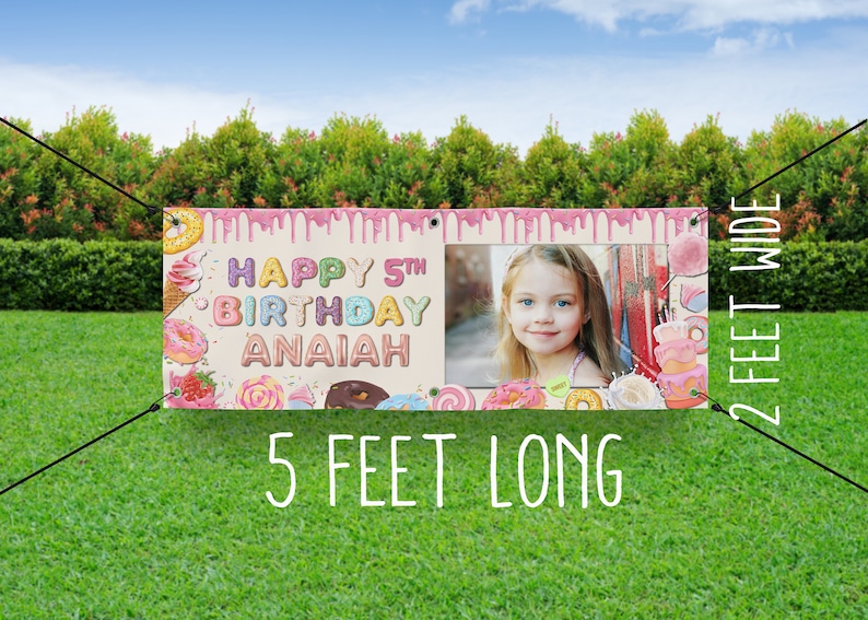 May include: A pink and white birthday banner with a donut theme. The banner says "Happy 5th Birthday Anaiah" and has a photo of a girl in the center. The banner is 5 feet long and 2 feet wide.