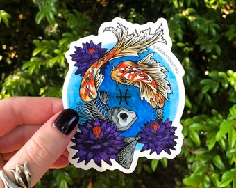 May include: A white sticker with a blue background and two koi fish, one with a skeleton, surrounded by purple water lilies. The Pisces zodiac symbol is in the center. The sticker says "@JULIAJODESIGNS".