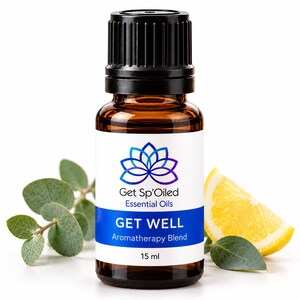 May include: A 15 ml amber glass bottle of essential oil with a black cap. The white label features a blue lotus flower icon, the text Get Sp'Oiled Essential Oils, GET WELL Aromatherapy Blend, and 15 ml. Eucalyptus leaves and a lemon slice.
