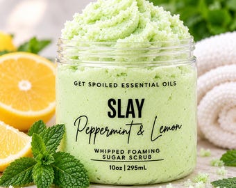 May include: A clear plastic jar filled with light green whipped foaming sugar scrub. The label reads GET SPOILED ESSENTIAL OILS SLAY Peppermint & Lemon WHIPPED FOAMING SUGAR SCRUB 10oz | 295mL. The scrub is topped with a textured swirl.