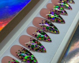 May include: Set of ten nude stiletto false nails with a gradient of iridescent green, gold, and purple glitter.