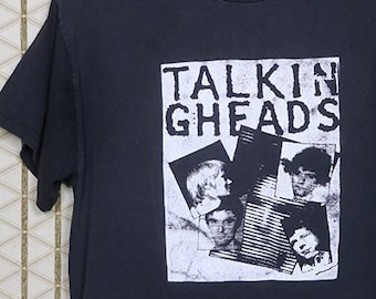 May include: A black t-shirt with a white print of the band "Talking Heads" with a collage of images of the band members.