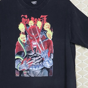 May include: Black t-shirt with a graphic print of a red demon with claws and a snake. The demon is surrounded by flames and skulls. The text "SHATTERED" is visible on the shirt's tag.