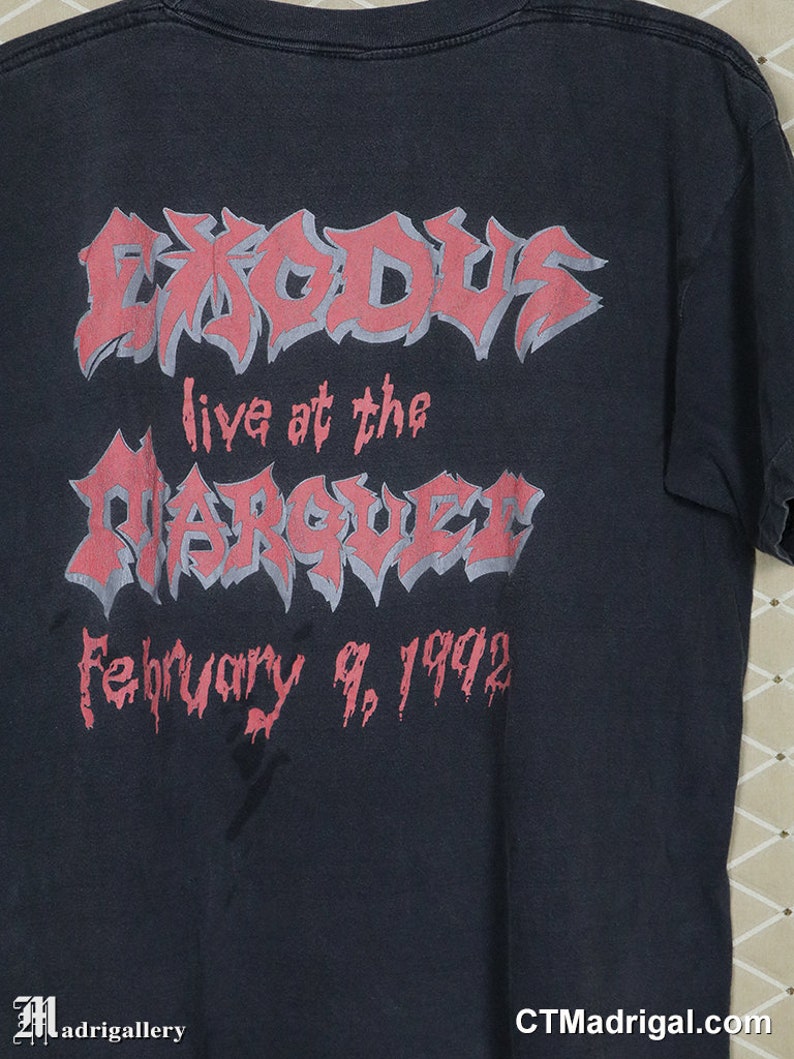 May include: Black t-shirt with a pink graphic of the band Exodus. The graphic says "Exodus live at the Marquee February 9, 1992".