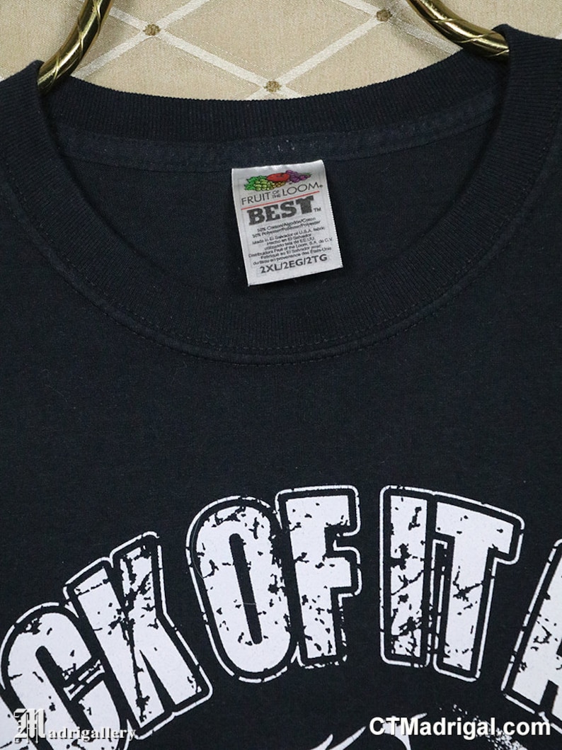 May include: Black t-shirt with a white distressed graphic that says "Sick of It" with a small graphic of a skull and crossbones below. The shirt is a size 2XL and is made by Fruit of the Loom.