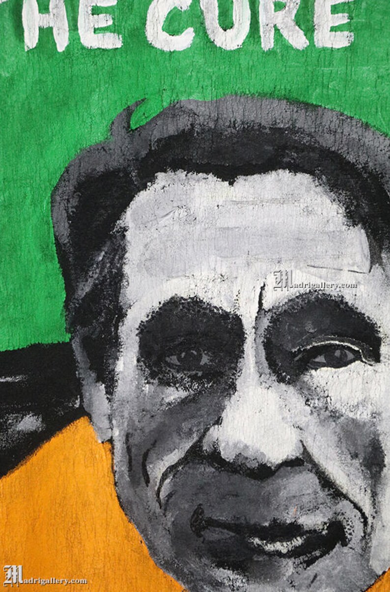 May include: A black and white painting of a man's face. The man has a white forehead, black eyes, and a gray beard. The background is green with the words "THE CURE" written in white.