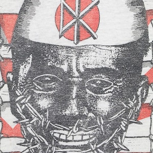 May include: A black and white illustration of a face with a barbed wire mouth. The face is wearing a white hat with a red circle and a black symbol in the center. The background is red and white.
