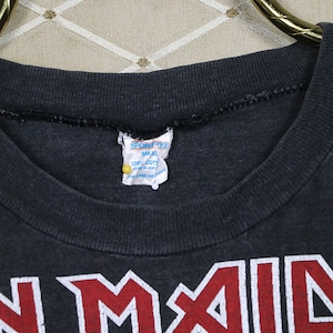 May include: Black t-shirt with a red and white "Iron Maiden" logo. The tag says "Sport Tee" and "Small" with "100% Cotton" and "Made in Korea".