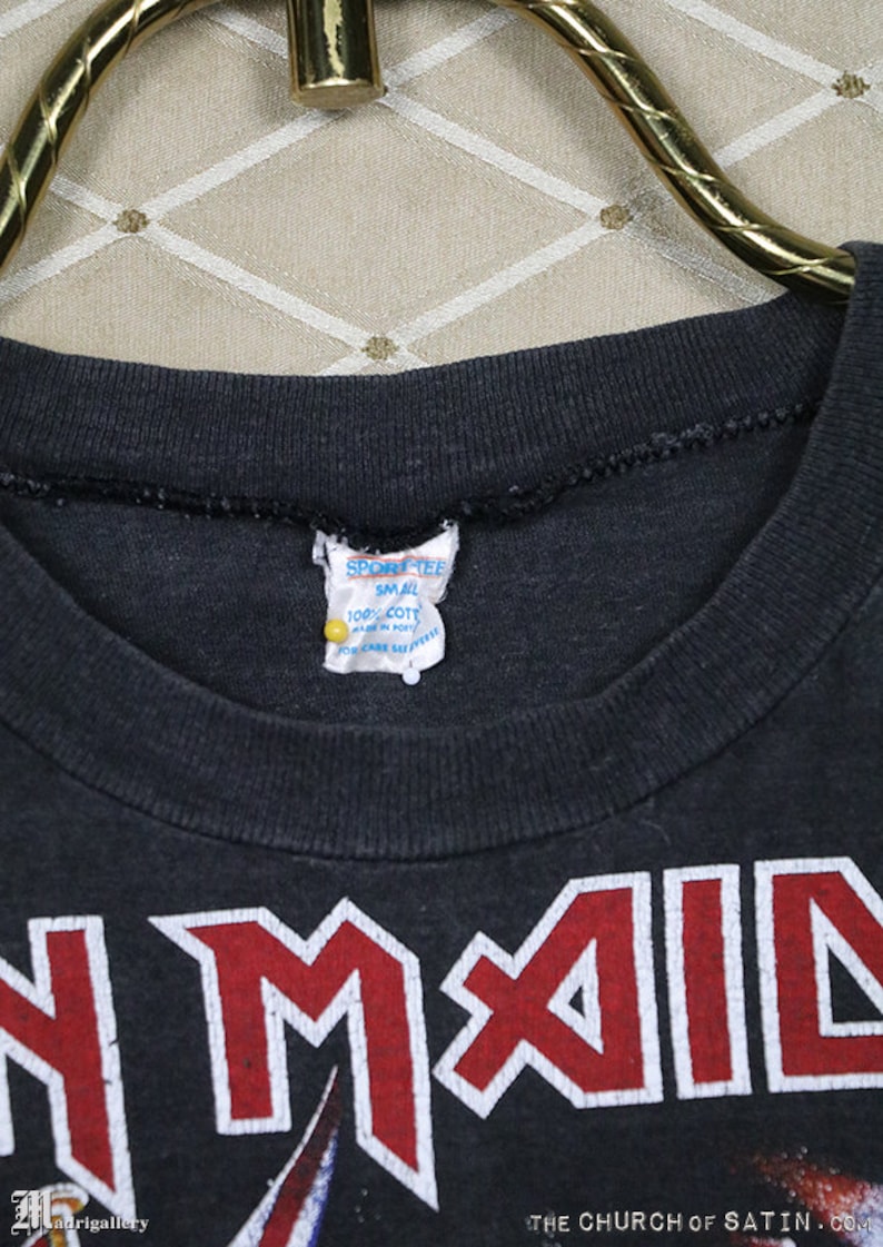 May include: Black t-shirt with a red and white "Iron Maiden" logo. The tag says "Sport Tee" and "Small" with "100% Cotton" and "Made in Korea".