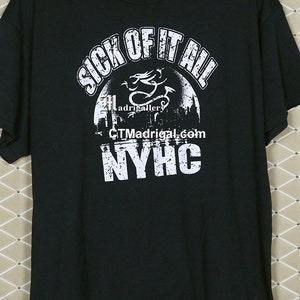 May include: Black t-shirt with a white graphic print that says "Sick of it all" with a dragon and the text "NYHC".