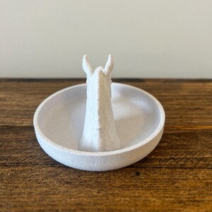 May include: White ceramic ring holder shaped like a horse's head.