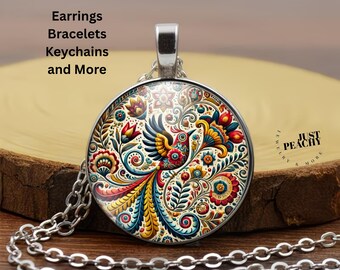 Puede incluir: Collar con colgante plateado con un diseño de pájaro colorido y detallado con detalles en rojo, amarillo, azul y verde. El colgante redondo cuelga de una cadena plateada. El texto en la imagen dice "Earrings, Bracelets, Keychains and More."