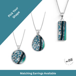 May include: Three silver pendant necklaces with different shapes: a circle, a teardrop, and a rectangle. Each pendant features a teal and silver abstract design. The necklaces are displayed on a white background. Text on the image says "Pick Your Shape" and "Matching Earrings Available".