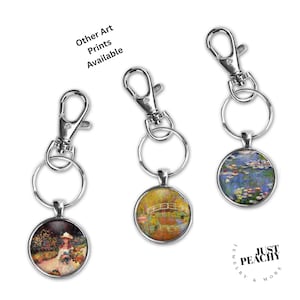 May include: Three keyrings with silver-tone clasps and round pendants displaying famous art prints. One pendant shows a woman in a garden, another a bridge over water, and the third a water lily pond. Text reads "Other Art Prints Available."