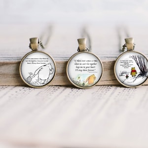 May include: Three round pendant necklaces with bronze-colored settings and chains. Each pendant features a Winnie the Pooh illustration and a quote: "If there ever comes a day when we can't be together, keep me in your heart, I'll stay there forever."