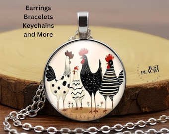 May include: A silver pendant necklace with a circular charm depicting four cartoon chickens. The chickens have different patterns, including spots and stripes. The text "Earrings Bracelets Keychains and More" is visible on the image.