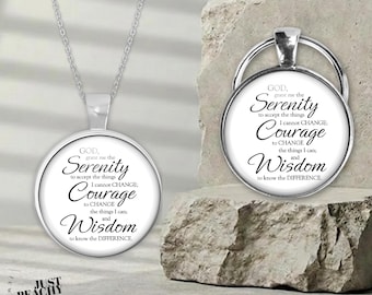 May include: A silver-toned necklace and a matching circular keychain, both featuring a white insert printed with the Serenity Prayer in black text. The text reads: God, grant me the Serenity to accept the things I cannot CHANGE; Courage to CHANGE the things I can; and Wisdom to know the DIFFERENCE.