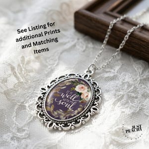 May include: Silver pendant necklace with an oval, decorative frame. The pendant has a purple background, floral details, and the words "It is well with my soul." The image also includes the text "See Listing for additional Prints and Matching Items."