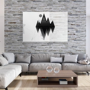 May include: A black and white geometric mountain range print with a circle above the peaks. The print is on a white background and measures 80 cm by 120 cm.