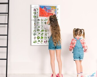 May include: Two children, one reaching up to hang a colorful educational poster on a white wall. The poster features illustrations of various vegetables and their names.
