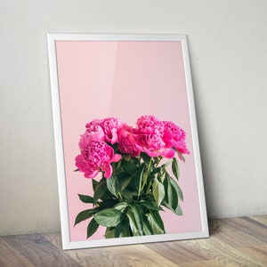 May include: A framed print of a bouquet of pink peonies against a light pink background.