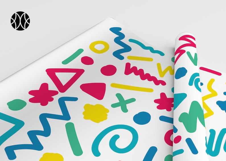 May include: White wrapping paper featuring a vibrant abstract pattern. The design incorporates shapes such as triangles, zigzags, and circles in pink, yellow, green, and blue. A rolled section of the paper is also visible.