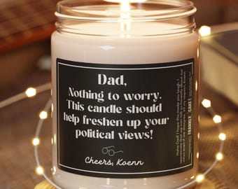 May include: A white candle in a glass jar with a black label that reads "Dad, Nothing to worry. This candle should help freshen up your political views! Cheers, Koenn".