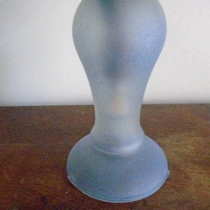 May include: A frosted glass lamp base in a light blue color. The base is round and has a flared design.