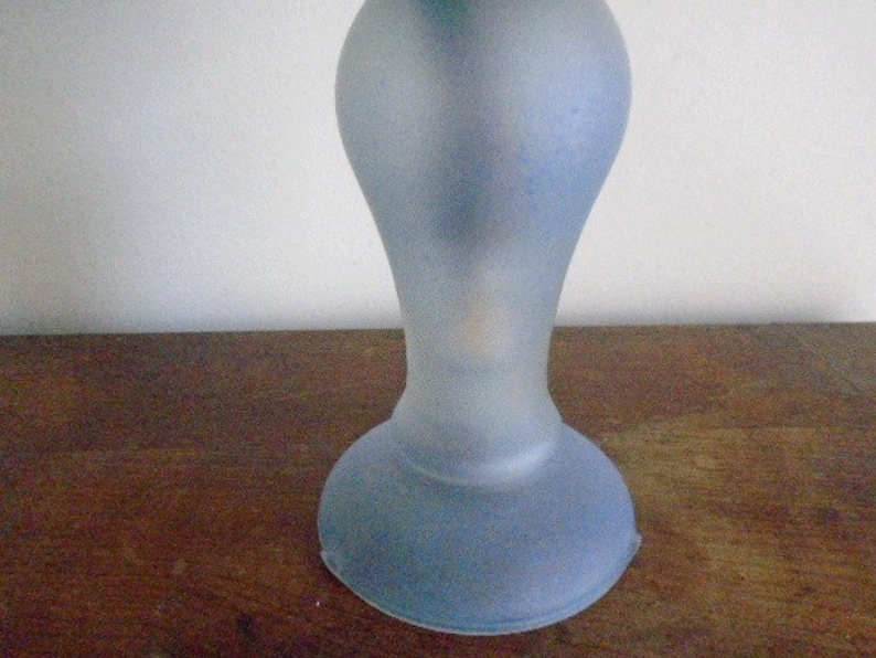May include: A frosted glass lamp base in a light blue color. The base is round and has a flared design.