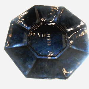 May include: A dark blue octagonal ceramic dish with a raised rim and a smooth, glossy finish.