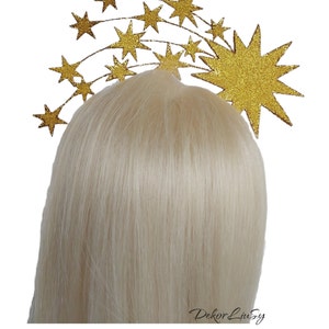 May include: Gold glitter star headband with a large star in the center and smaller stars arranged in a curved line.