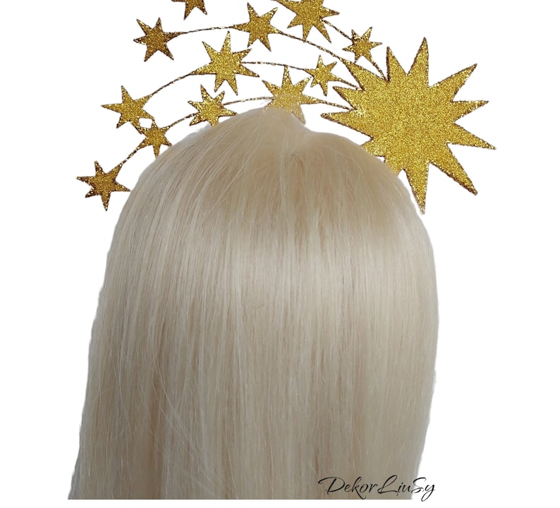 May include: Gold glitter star headband with a large star in the center and smaller stars arranged in a curved line.