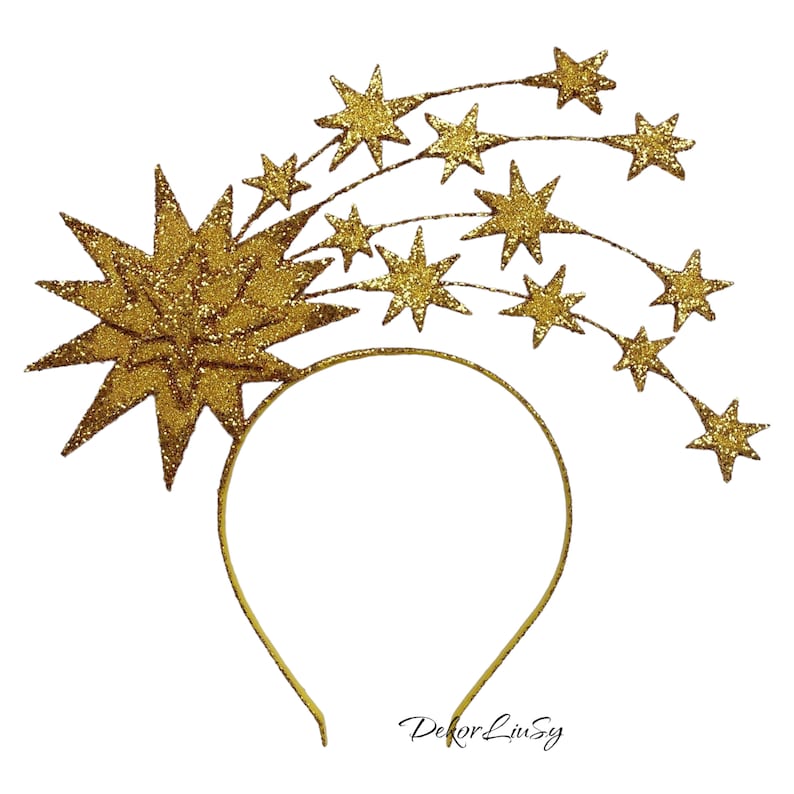May include: Gold glitter star headband with a large star in the center and smaller stars trailing behind it. The headband is made of a thin gold wire.