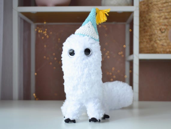 A hand-crocheted bendable desk creature with anime-inspired fluffiness — the kind of weird little guy you didn't know you needed watching over your workspace.