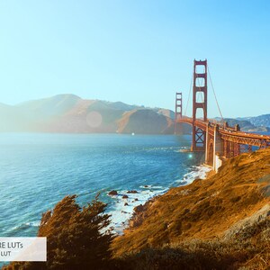 May include: A scenic view of the Golden Gate Bridge in San Francisco, California. The bridge is a red steel suspension bridge spanning the Golden Gate strait, connecting San Francisco to Marin County. The bridge is seen from a distance, with the water and hills in the background.