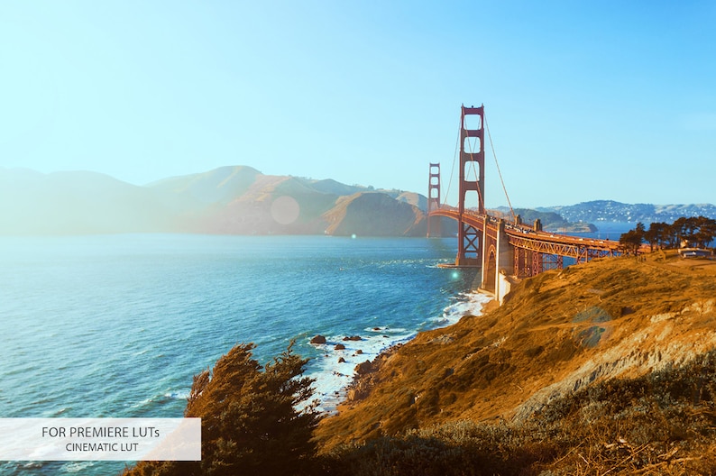 May include: A scenic view of the Golden Gate Bridge in San Francisco, California. The bridge is a red steel suspension bridge spanning the Golden Gate strait, connecting San Francisco to Marin County. The bridge is seen from a distance, with the water and hills in the background.