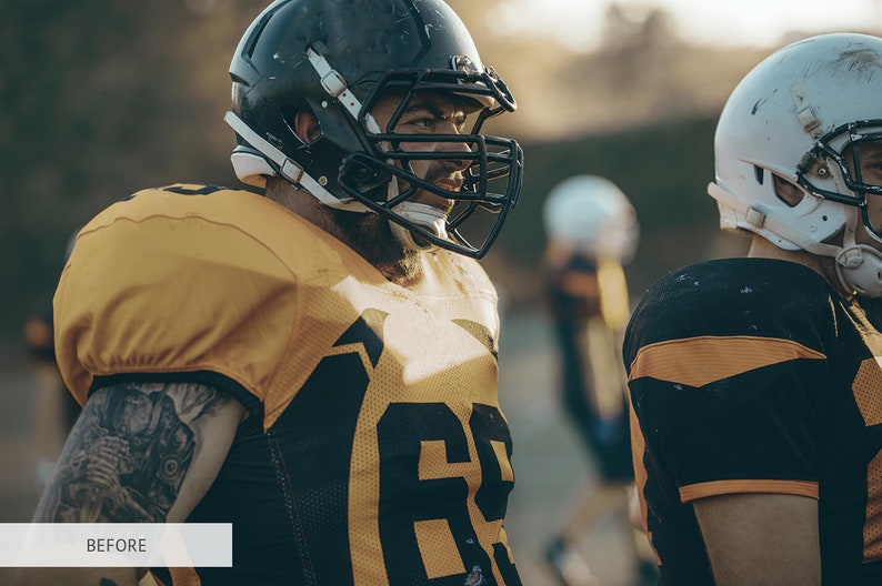 May include: Two football players wearing helmets and jerseys stand on a field. The player on the left is wearing a yellow jersey with a black number 68. The player on the right is wearing a black jersey with a yellow stripe.