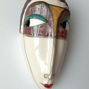 wall hanging mask, handmade wall mask, pottery wall decor, artisan ceramic mask, decorative face mask, unique wall sculpture