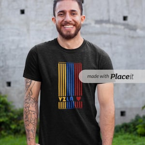May include: A black t-shirt with a yellow, blue, and red vertical stripe design. The word "Yzla" is printed in white letters on the stripes, and a red heart is to the right of the word.