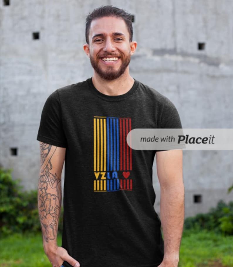 May include: A black t-shirt with a yellow, blue, and red vertical stripe design. The word "Yzla" is printed in white letters on the stripes, and a red heart is to the right of the word.