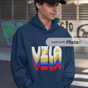 May include: A navy blue hoodie with a colorful retro-style graphic that says "VZLA".
