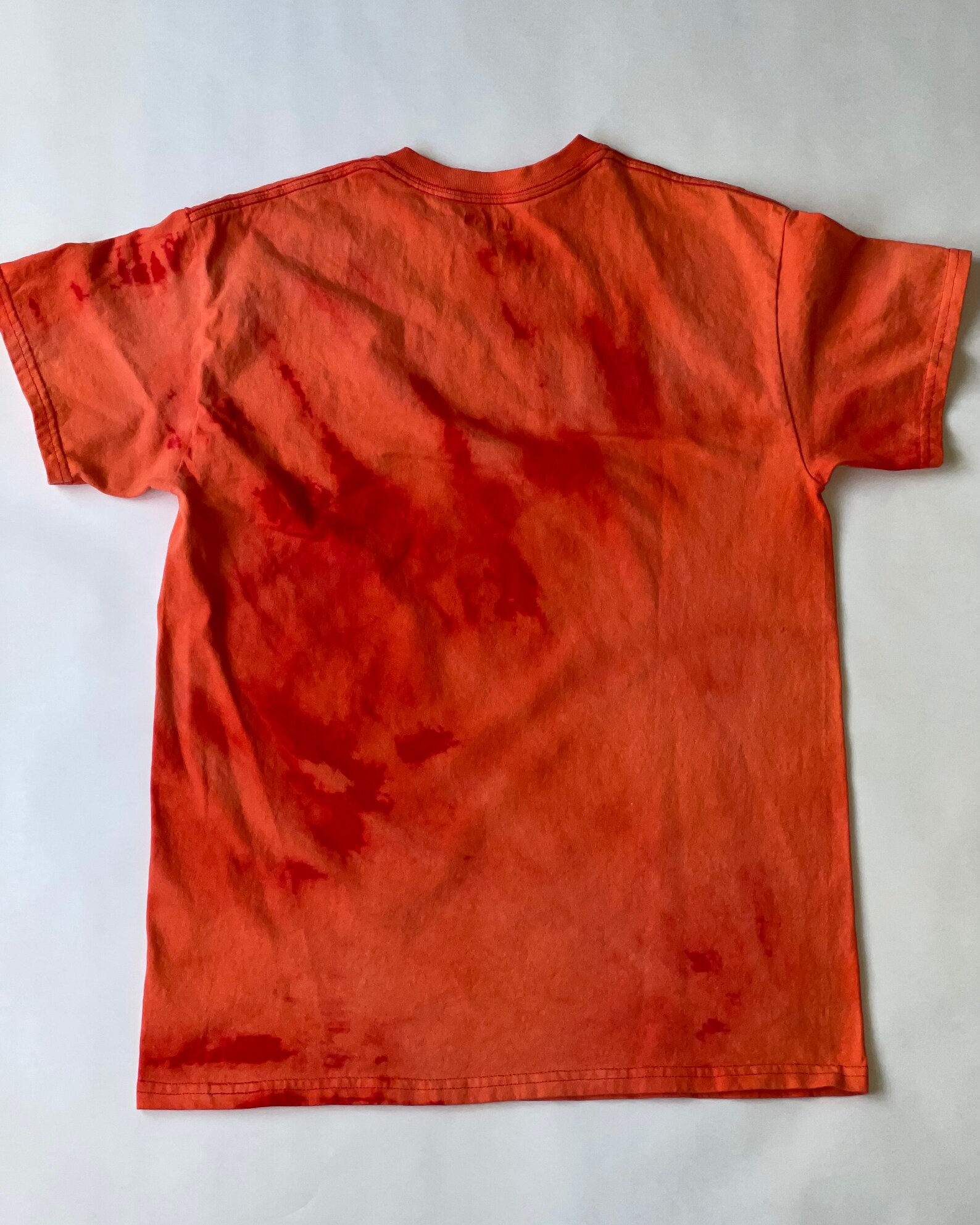 reverse tie dye orange shirt