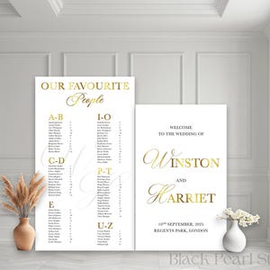 May include: Two white wedding signs with gold lettering. One lists names alphabetically, the other welcomes guests to Winston and Harriet's wedding on 10th September, 2025, in Regents Park, London. A vase of flowers and pampas grass are in the scene.