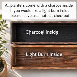 May include: Two rectangular wooden planters, one with a charcoal interior and the other with a light burn interior. The text on the image reads "Charcoal Inside" and "Light Burn Inside". The planters are likely for plants or flowers.