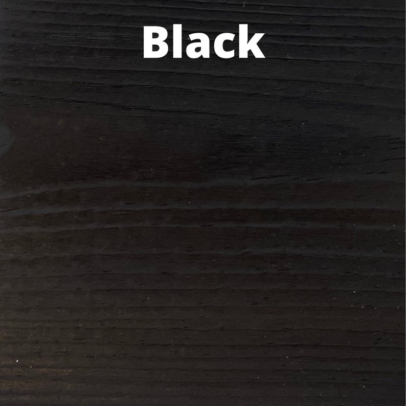 May include: Close-up of a black wood grain surface. The word "Black" is written in white text on the surface.