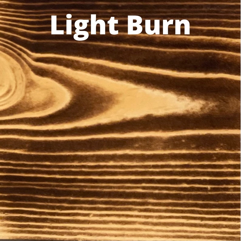 May include: Close-up of a wood surface with a light brown burn finish. The wood grain is visible and has a natural, rustic look.